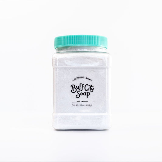 Aloe and Clover Laundry Soap in container with teal lid against white background