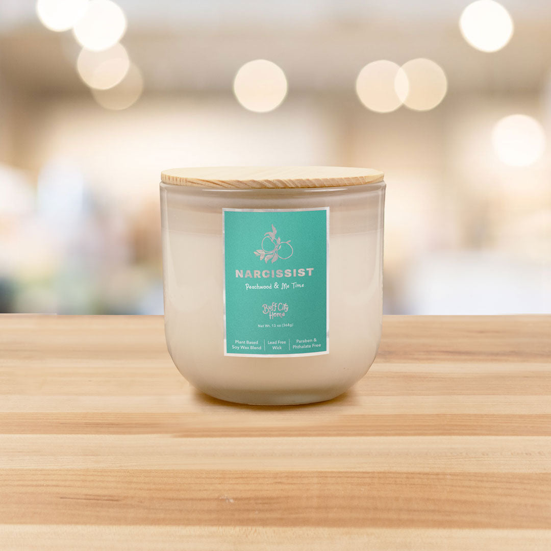 Narcissist 2-Wick Candle with raspberry, peach, patchouli, and sandalwood scent