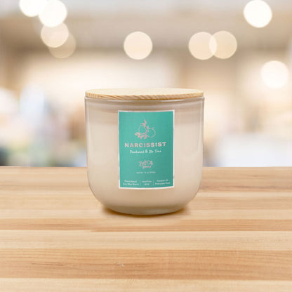 Narcissist 2-Wick Candle with raspberry, peach, patchouli, and sandalwood scent