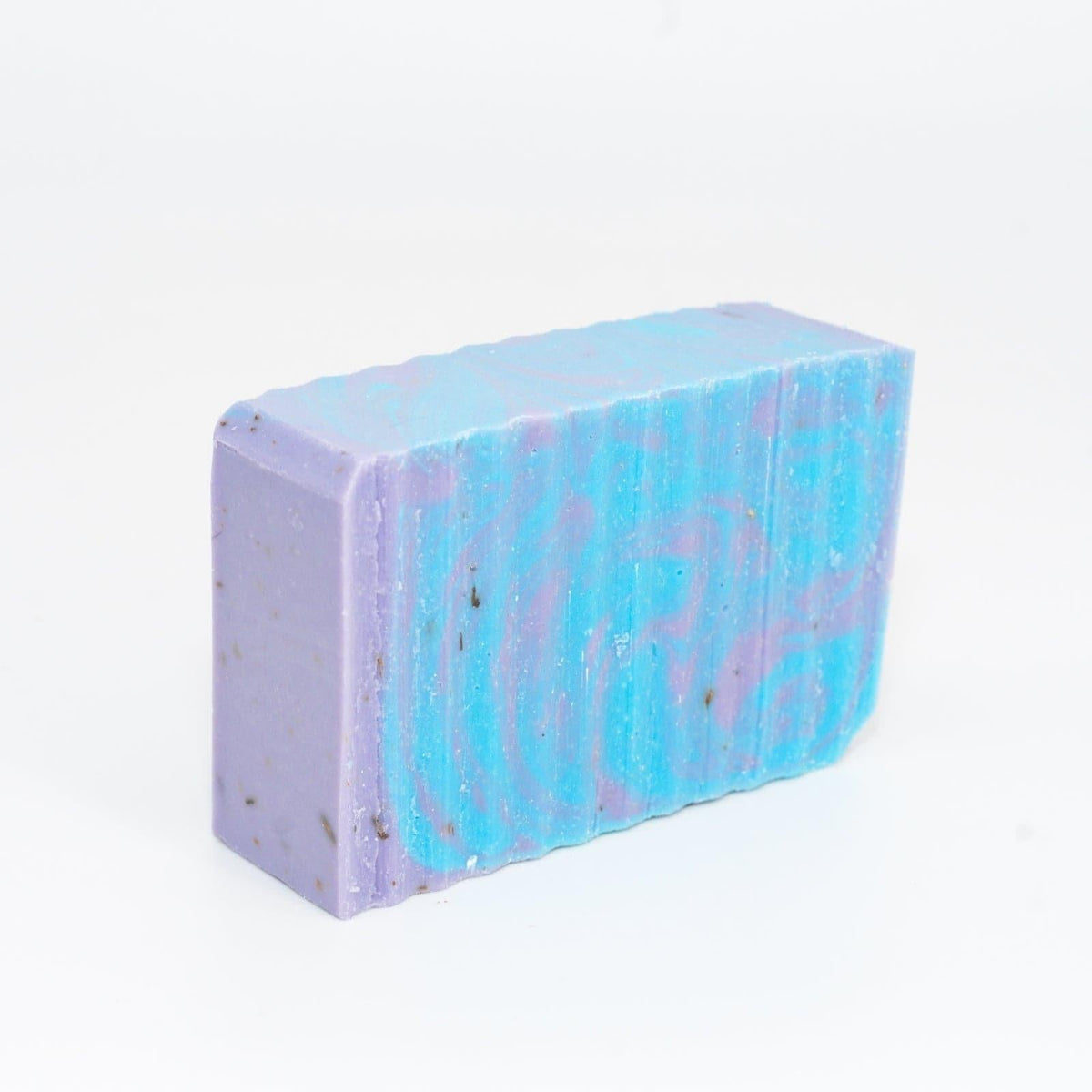 A bar of Buff City Soap's lavender colored with blue and purple swirls