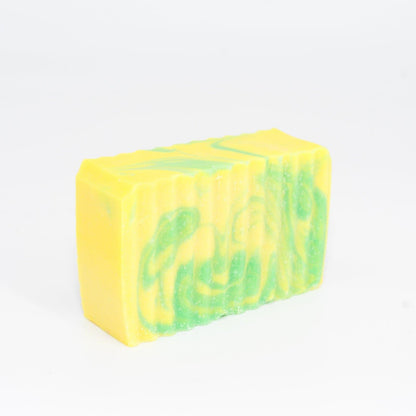 A bar of yellow and green colored Buff City Soap's lemongrass + eucalyptus soap