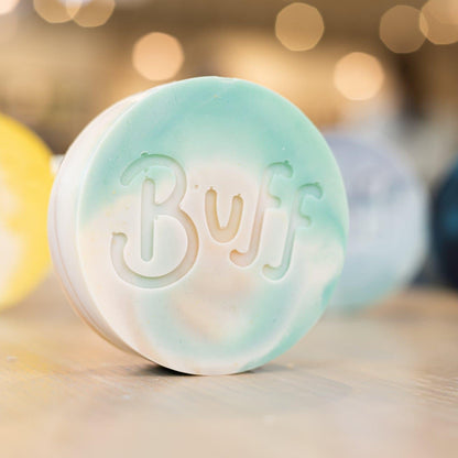 angled right view of teal and white Narcissist Shave Bar with "Buff" engraved in bar