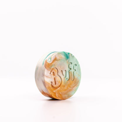 angled right view of teal, white, and orange Narcissist Shave Bar with "Buff" engraved in bar